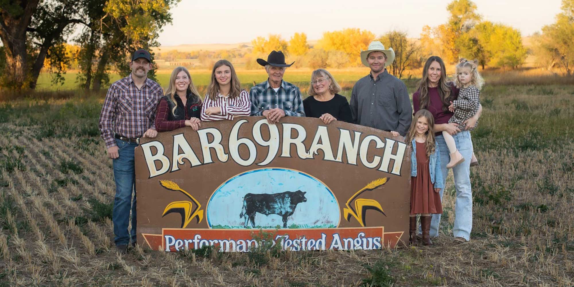 Family standing behind Bar 69 sign